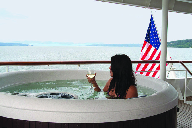 woman with a glass of wine in hot tub on safari endeavour ship