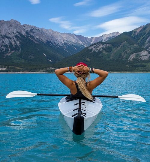 girl relaxing while kayaking on water